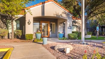 Estancia leasing office entrance with nice well trimmed greens